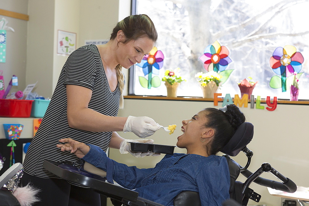 Teen with Spastic Dystonic Cerebral Palsy and assistant at school