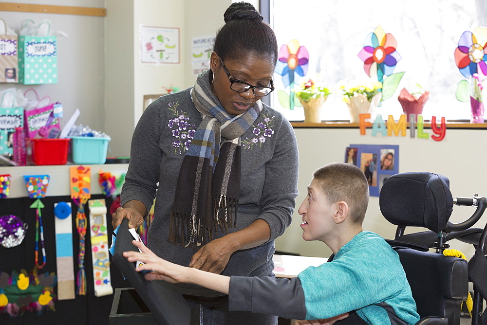 Teen with Holoprosencephaly and assistant at school