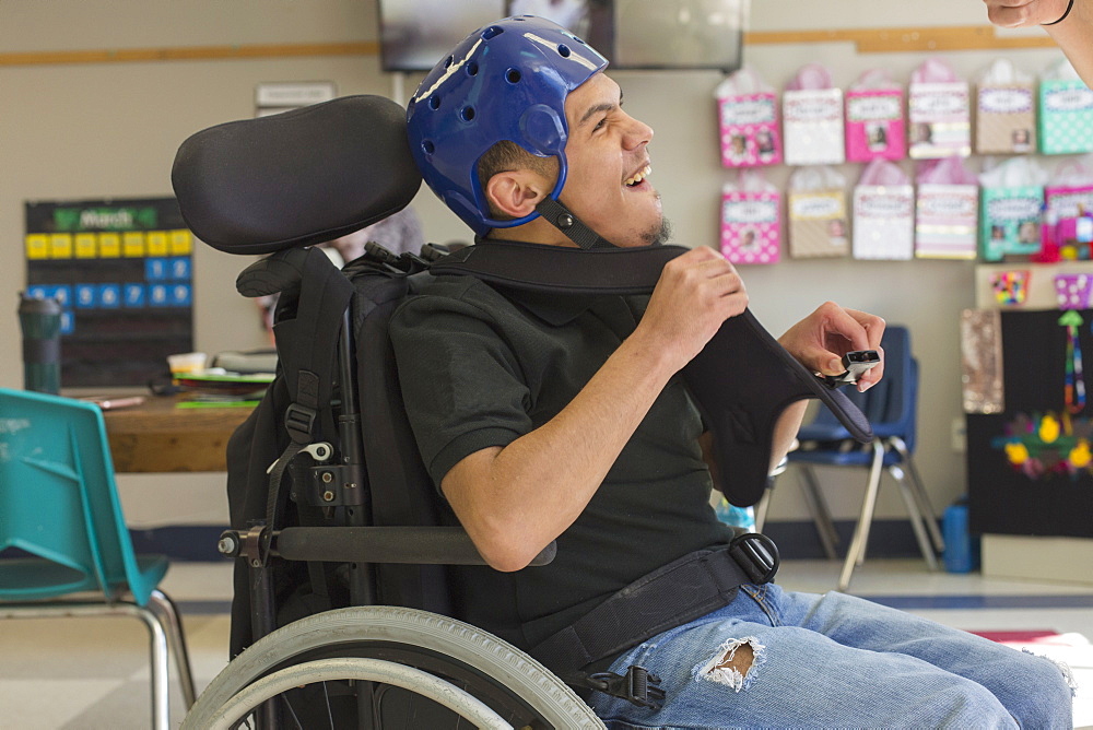 Boy with Spastic Quadriplegic Cerebral Palsy using using his special needs helmet