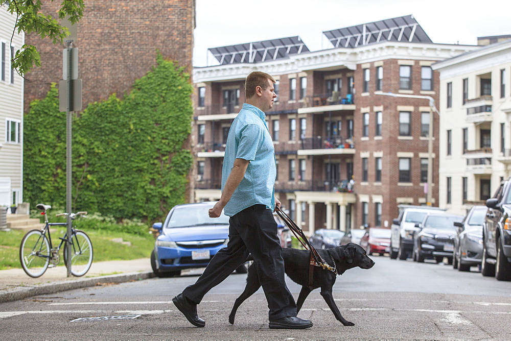 Man with Visual Impairment walking with his service dog