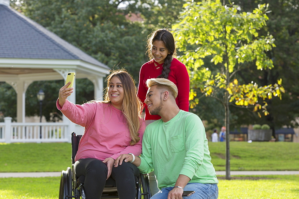 Three friends taking selfie, one with a Spinal Cord Injury