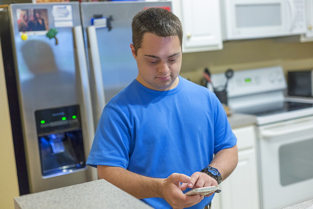 Man with Down Syndrome using a mobile phone