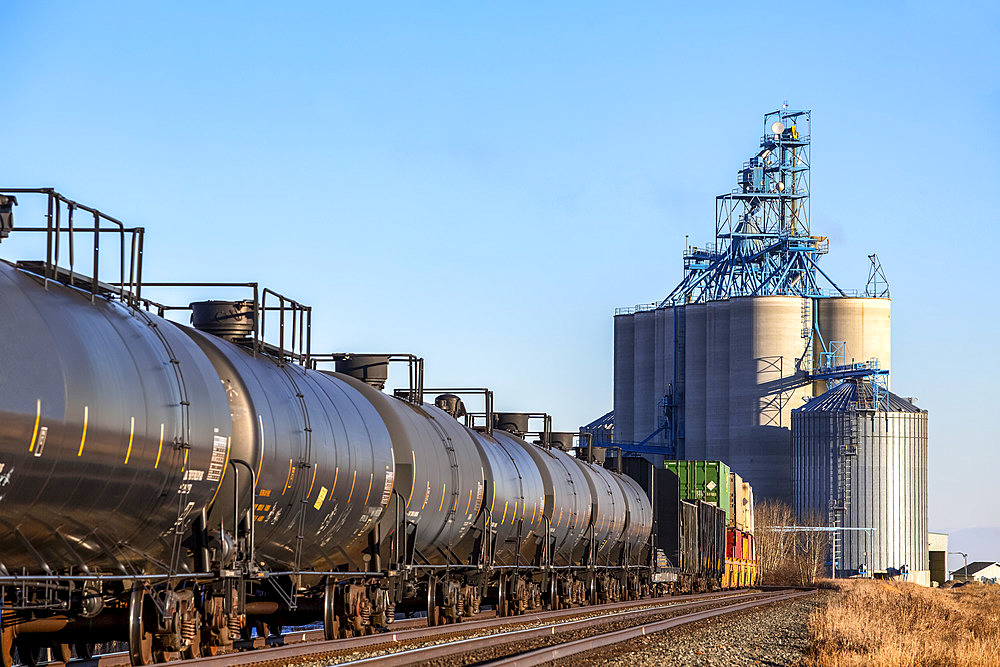 Tank cars on a train approaching a grain storage facility; Alberta, Canada