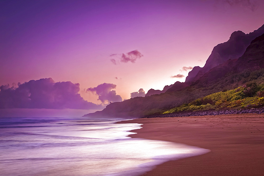 Pastel sunset sky over the rugged mountains along the Na Pali Coast, Kalalau Beach, Na Pali Coast State Park; Kauai, Hawaii, United States of America