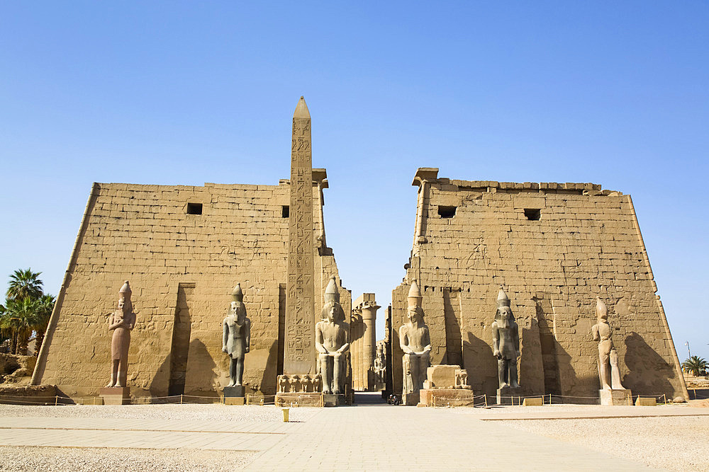 Six Colossi of Ramses II in front of Pylon, Obelisk, Luxor Temple, UNESCO World Heritage Site; Luxor, Egypt