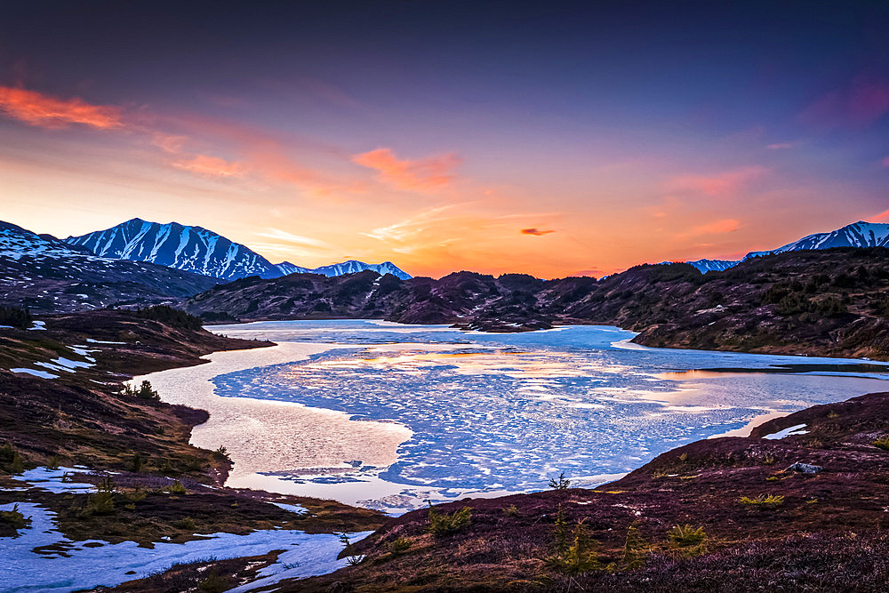 Half frozen Lost Lake at evening, Chugach Mountains in the background. Chugach National Forest, Kenai Peninsula, South-central Alaska in springtime; Seward, Alaska, United States of America