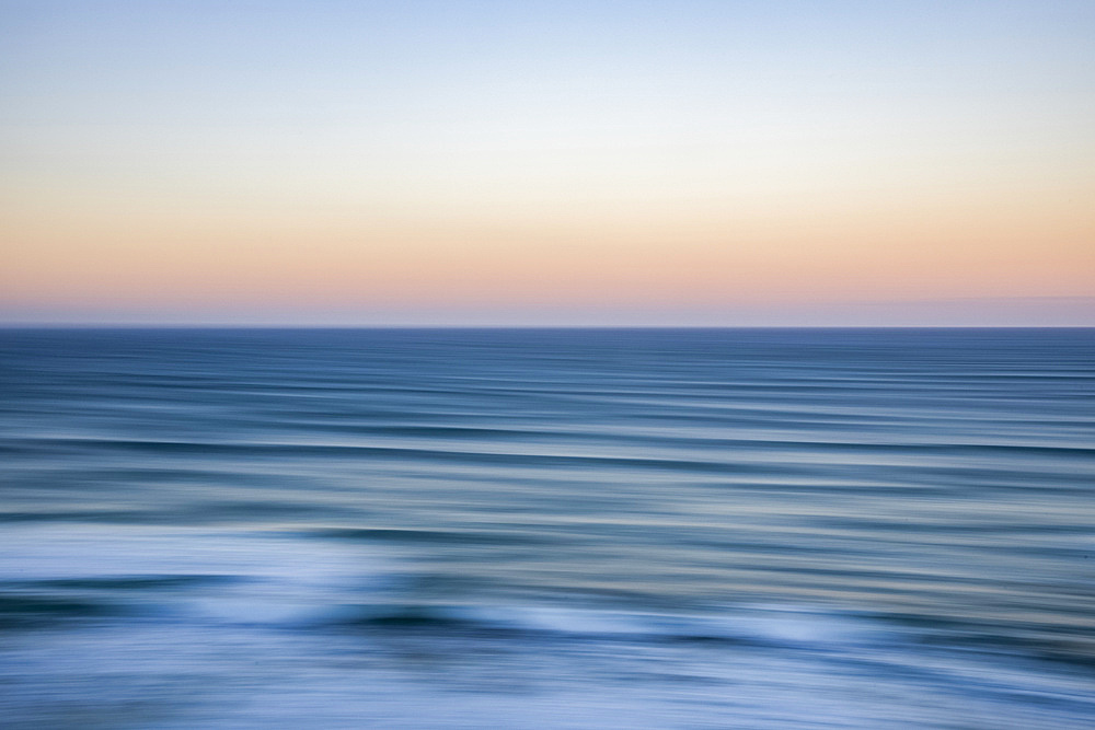 Panning sunrise over ocean, viewed from The Twelve Apostles, Port Campbell National Park; Port Campbell, Victoria, Australia