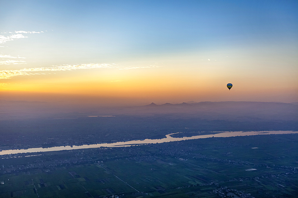 Hot air balloon over the Nile at dawn; Luxor, Egypt