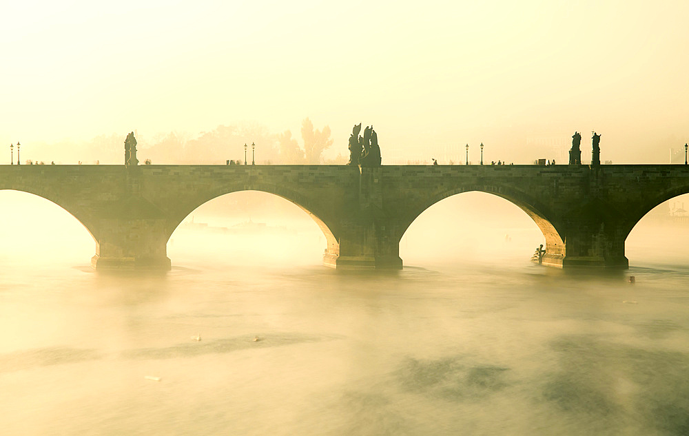 Early morning mist around Charles Bridge on the Vltava river; Prague, Czech Republic