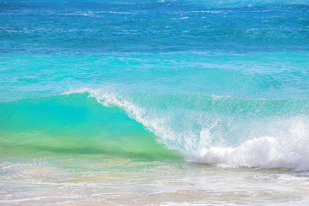 Splashing waves along the shore of white sand; Oahu, Hawaii, United States of America