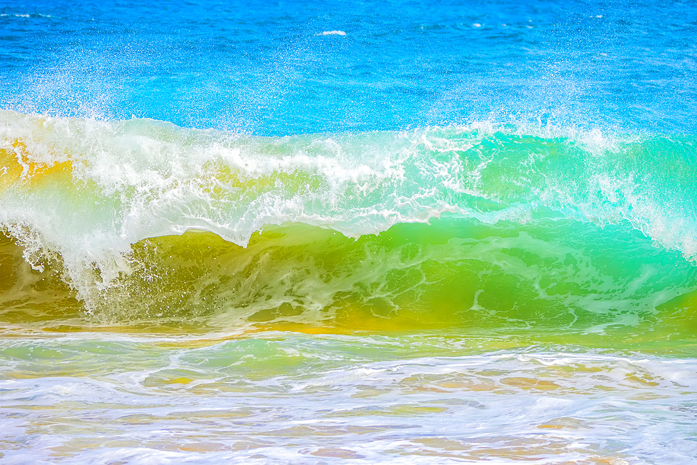 Splashing waves along the shore of sand; Oahu, Hawaii, United States of America