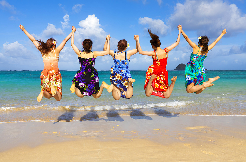 A group of Japanese students on vacation at Lanakai Beach with the Mokes Islands in the background: Oahu, Hawaii, United States of America