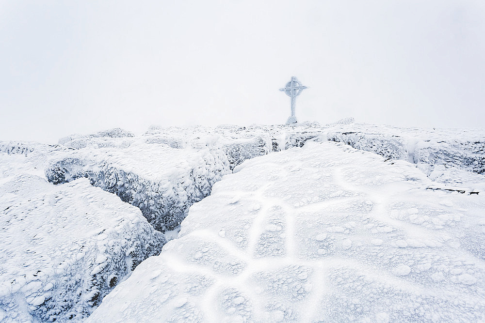 Frozen ice formations on the summit of Galtymor mountain with a celtic cross in winter, Galty Mountains; County Tipperary, Ireland