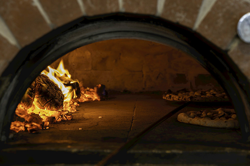 Two pizzas in a wood-fired pizza oven; Melbourne, Victoria, Australia