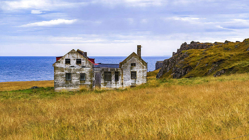 A weathered and abandoned house along the coast; Iceland