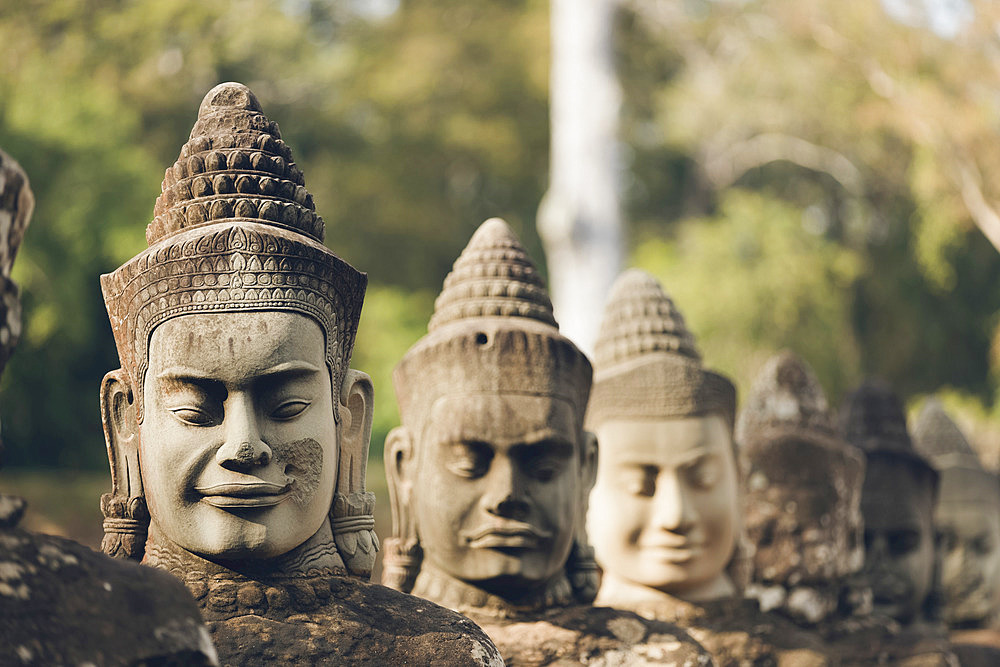 Head sculptures at South gate to Bayon temple, Angkor Wat complex; Siem Reap, Cambodia