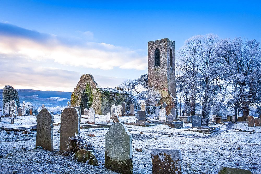 Shanrahan Church, an old church ruins and graveyard covered in snow at sunrise; Adrfinnan, County Tipperary, Ireland