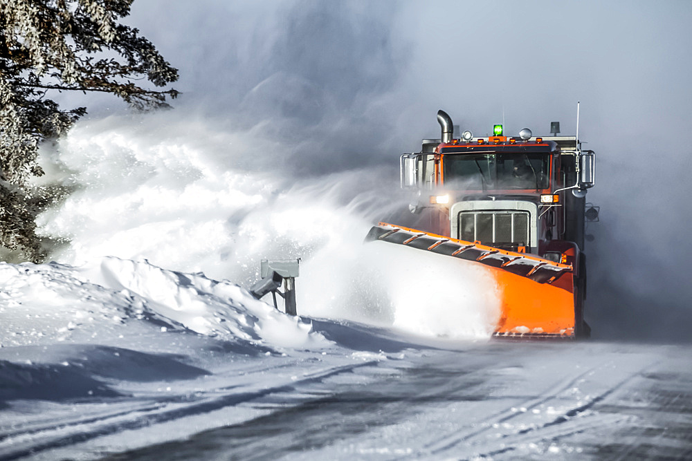 Snow plow throwing fresh snow to the side of the road; Sault St. Marie, Michigan, United States of America