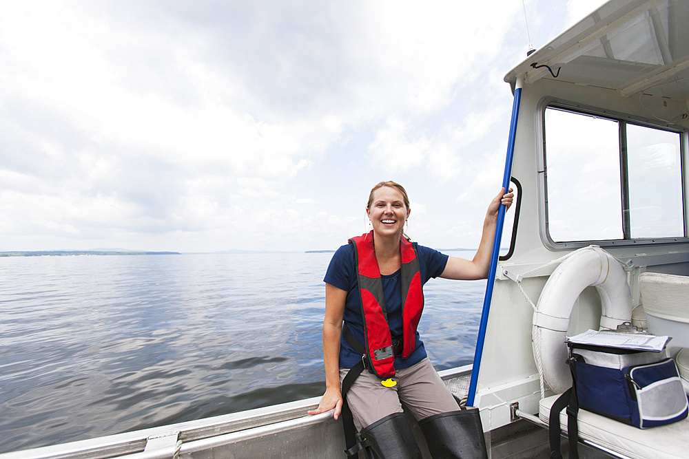 Public works engineer on service boat in reservoir