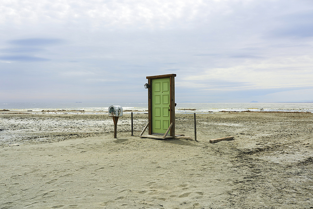 Bombay Beach door sculpture art on beach with Salon Sea in background; Bombay Beach, California, United States of America