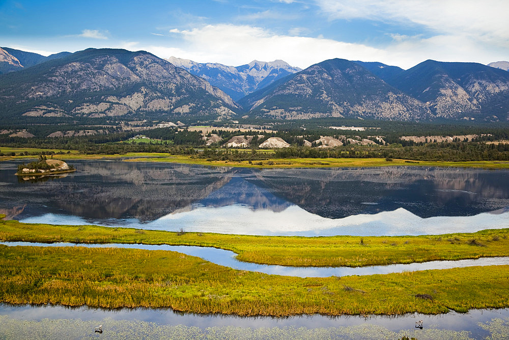 Columbia National Wildlife Area in foreground, Canadian Rockies across from Rocky Mountain Trench near Invermere, BC, Canada