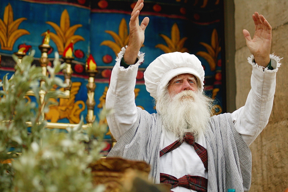 Priest Raises His Hands Toward Heaven