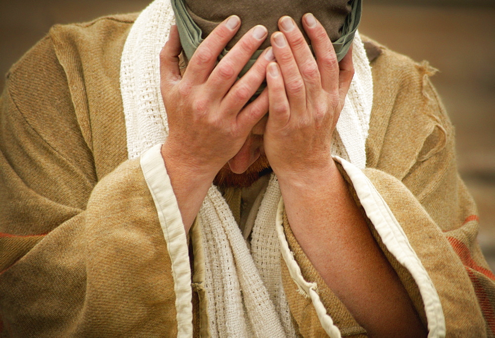 A Man With Hands Over His Face