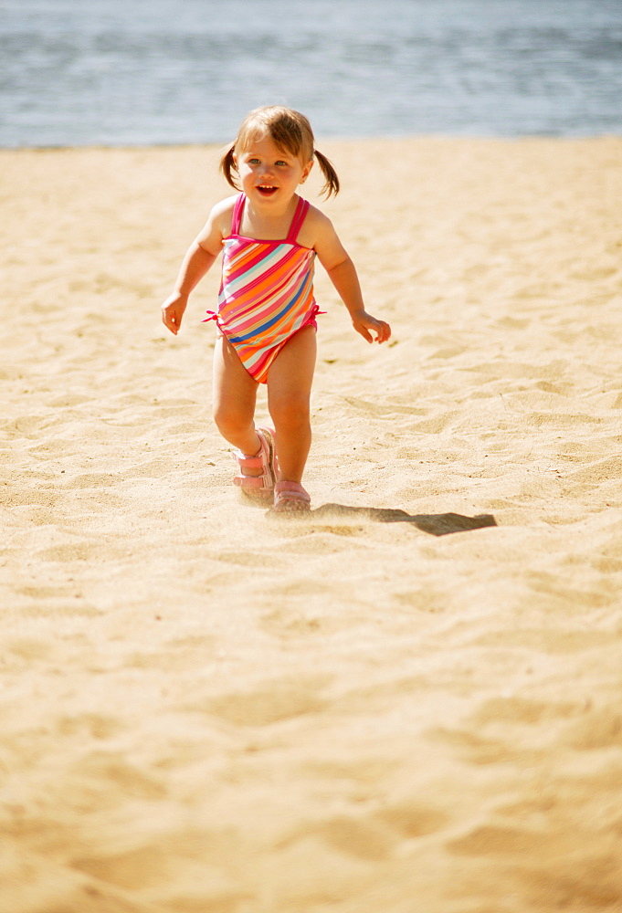 Child Runs On The Beach