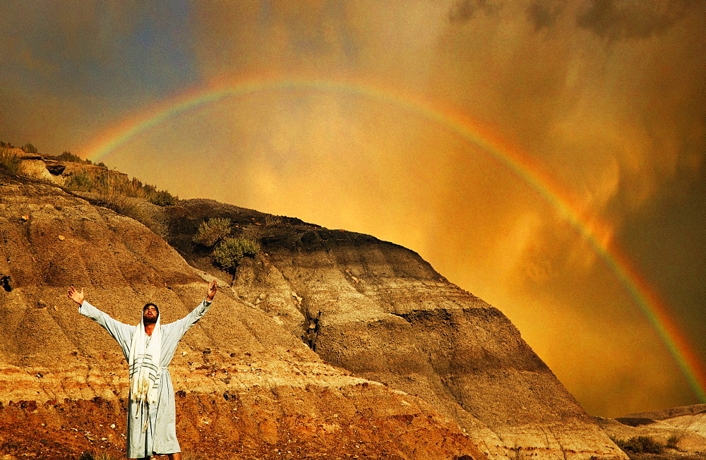 Man With Outstretched Arms, Rainbow In Background