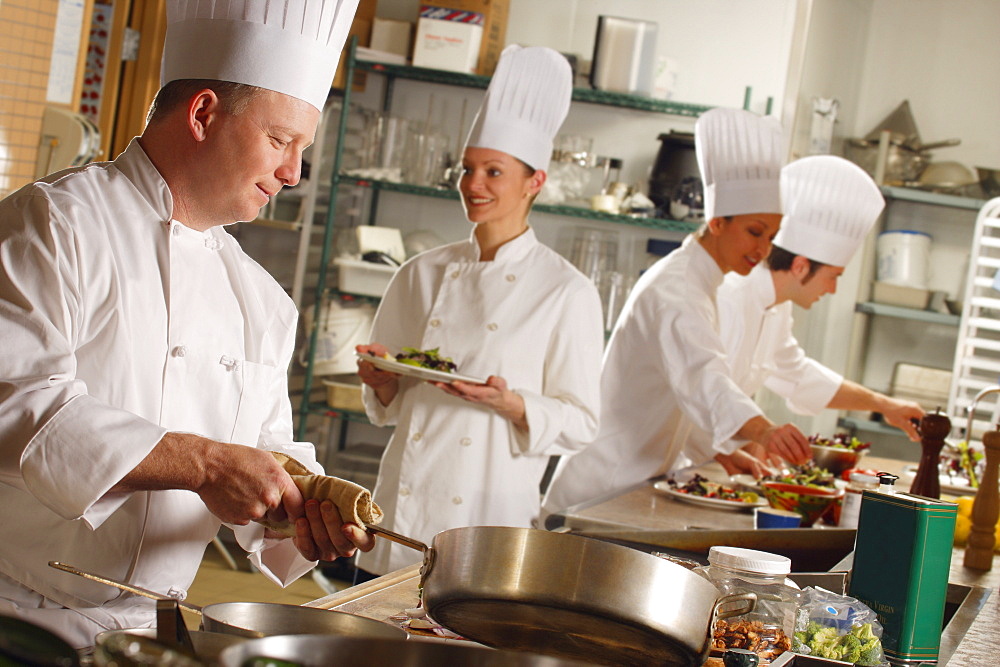 Chef's Preparing Food In A Kitchen