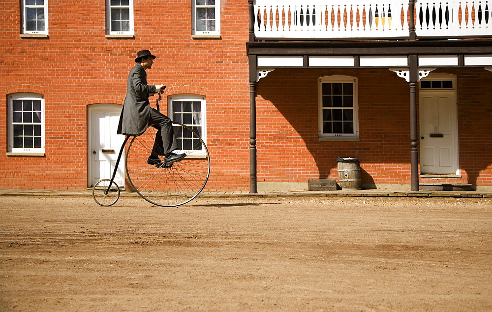 Man Riding Antique Bicycle