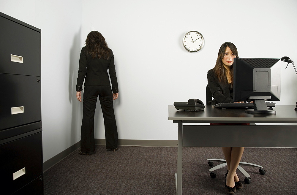 Businesswoman Facing Corner In Office