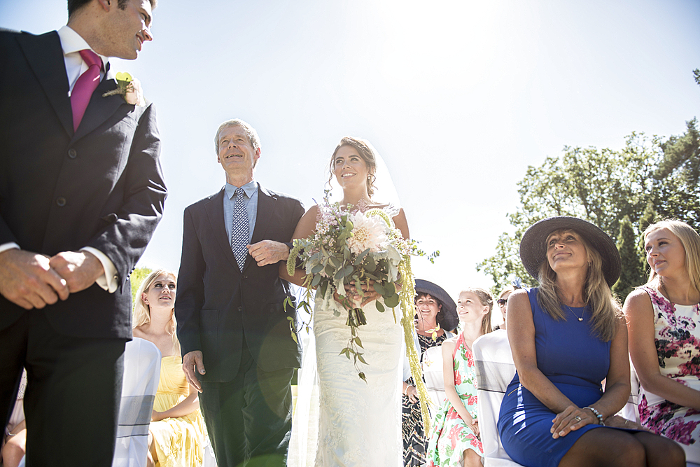 A proud father walks his daughter down the isle on her wedding day