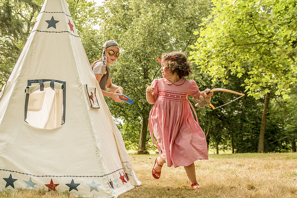 Young children play games outside in the sunshine