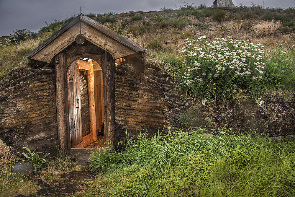 Stone and turf structure with wooden doorway at the recreated longhouse in Greenland's Brattahlid, Eriksfjord area, part of a reconstruction of Erik the Red's settlement, Kujataa World Heritage Site, Qassiarsuk, Southern Greenland, Greenland