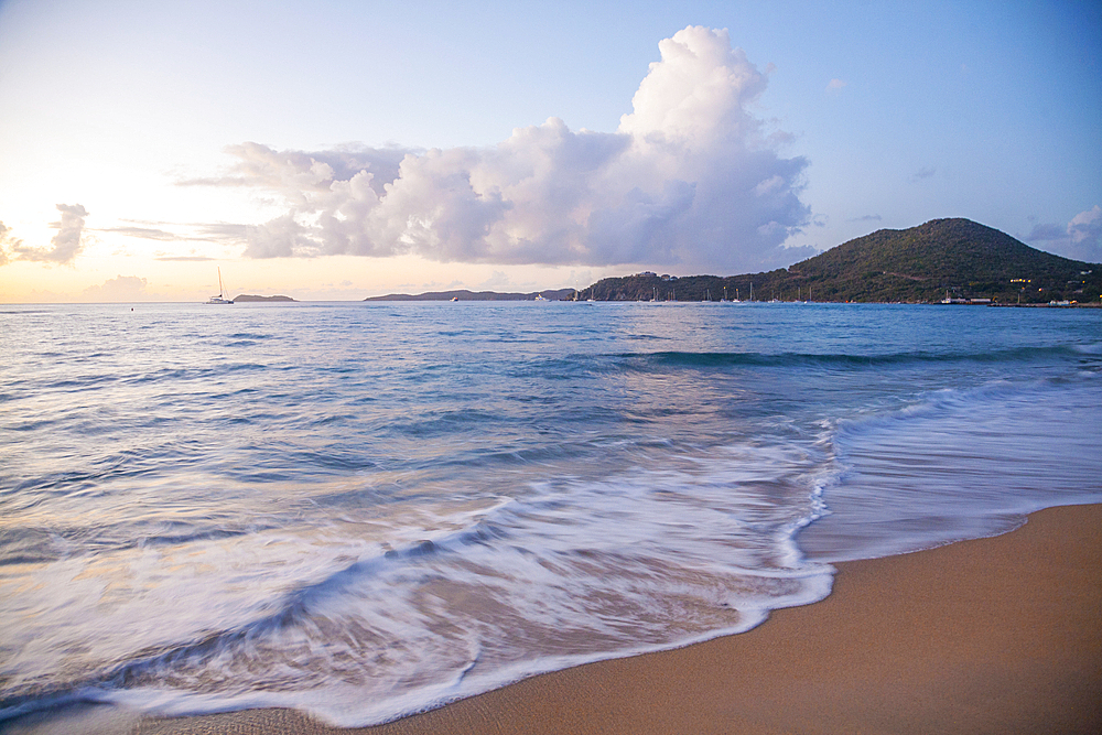 Scenic view of the seaside surf on a beach near the harbor on Virgin Gorda at twilight, British Virgin Islands, Caribbean