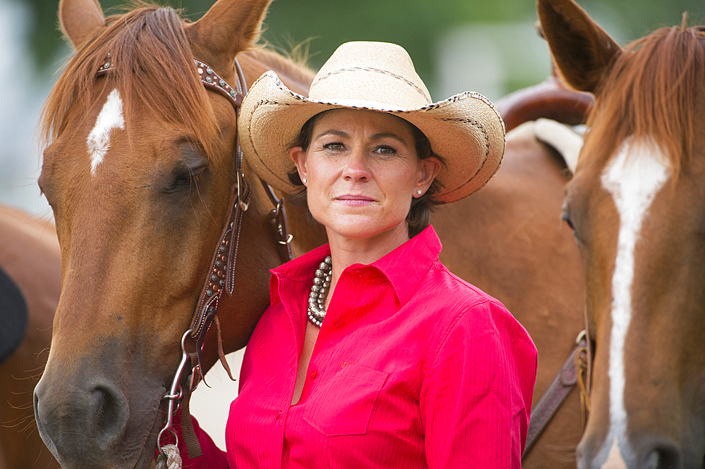 Rodeo queen stands with her horse, Burwell, Nebraska, United States of America