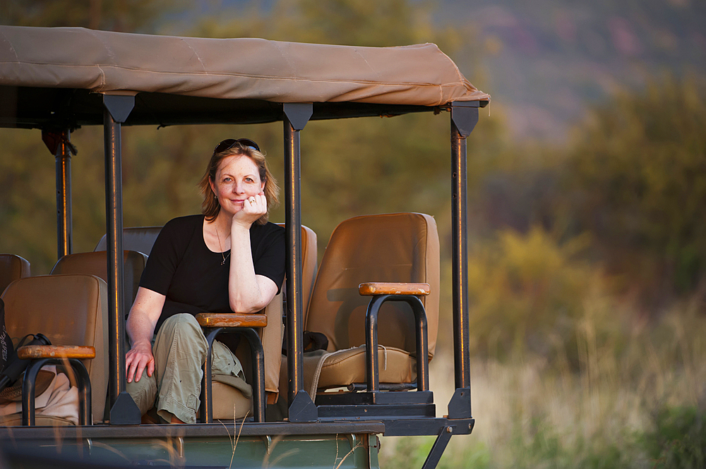 Woman enjoys a safari tour at Madikwe Game Reserve in South Africa, South Africa