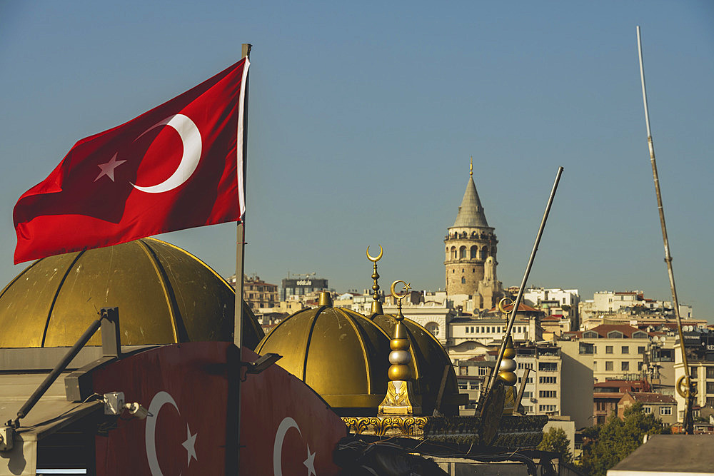 Galata Tower and the national flag of Turkey in Beyoglu, Istanbul, Turkey