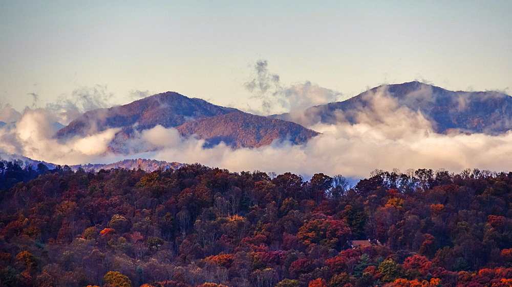 Clouds rise up from the valleys