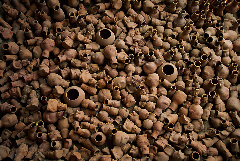 Clay pots piled on a tomb of the Lord of Sipan archeological site near Chiclayo, Peru in the Lambayeque Valley. Archaeologists uncovered burial places of several lesser important figures besides royalty at Sipan. One, a high priest, had a tomb almost as impressive as the royal ones. Another burial contained 1,137 pots shaped into warriors, priests, prisoners, musicians, and anthropomorphic deities, Sipan, Peru