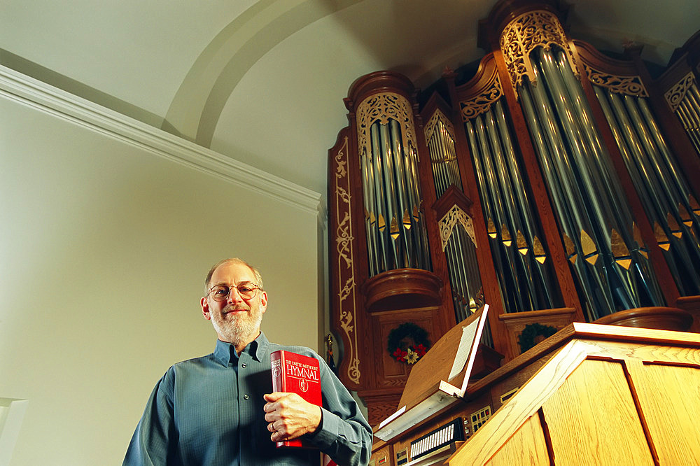 Organ manufacturer in a church with one of his company's organs, Lincoln, Nebraska, United States of America