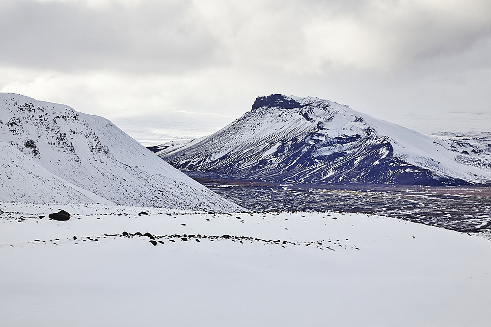 Snow-clad mountains in early winter in the Kaldidalur Valley, seen from Langjokull Glacier, in the western Highlands of west Iceland, Iceland