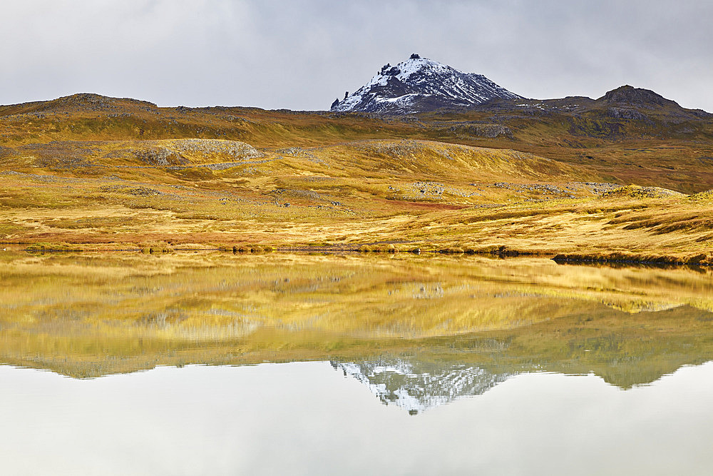 Mountains reflected in a tranquil lake at Valafell mountain pass, near Olafsvik, Snaefellsnes peninsula, west coast of Iceland, Iceland