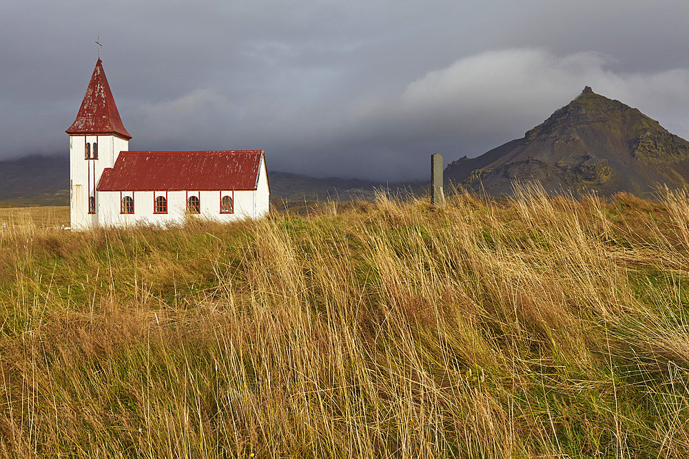 Church in the countryside of western Iceland with grass fields and rocky landforms, Hellnar, Snaefellsnes, Iceland