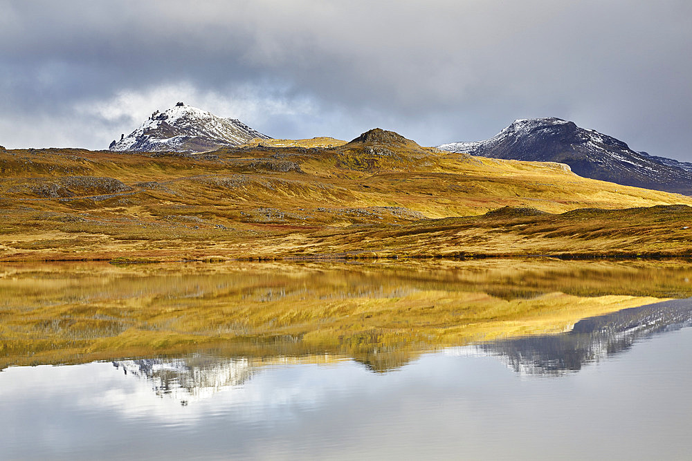 Mountain peaks reflected in a lake at Valafell mountain pass, near Olafsvik, Snaefellsnes peninsula, west coast of Iceland, Iceland