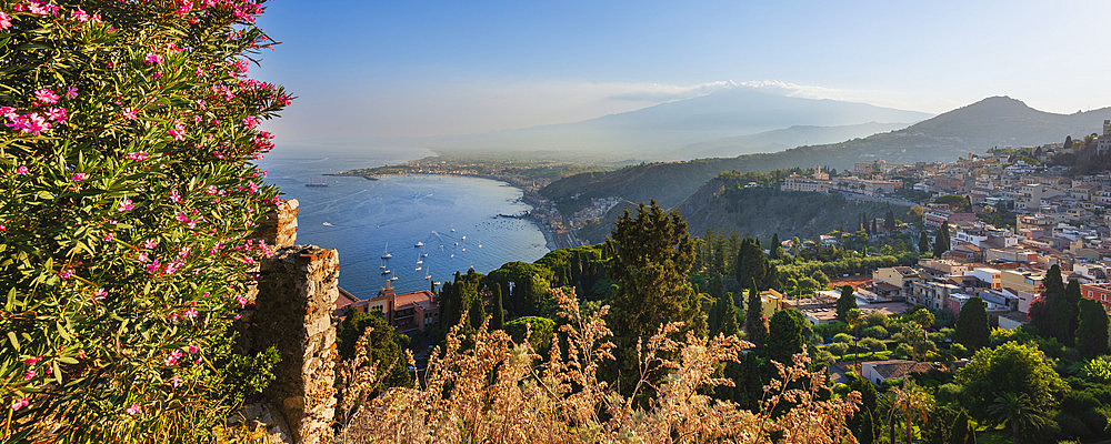 View of the town of Taormina with Mount Etna in the distance, Sicily, Italy, Taormina, Sicily, Italy