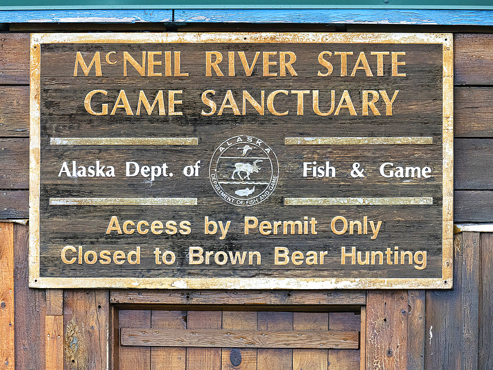 Close-up of a sign at the McNeil River State Game Sanctuary. McNeil River Camp is operated by the Alaska Department of Fish and Game. The Department hosts guests in small numbers throughout the summer and early fall and provides bear-viewing tours. Guests must enter and be drawn in an annual lottery to be granted access to this world-famous brown bear sanctuary, Alaska, United States of America