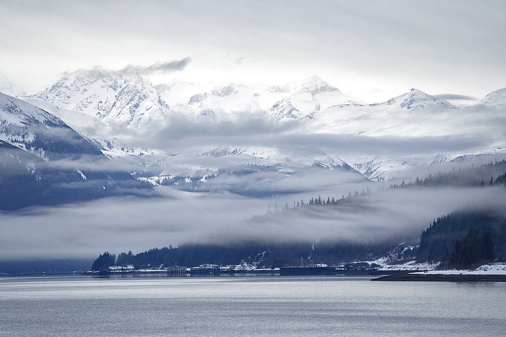 Very moody scene as the fog slowly lifts from the mountains in Haines, Alaska, USA, Haines, Alaska, United States of America