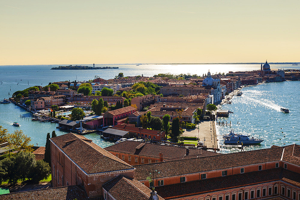 View of a canal and lagoon at sunset from the bell tower of the church of San Giorgio Maggiore, Venice, Italy